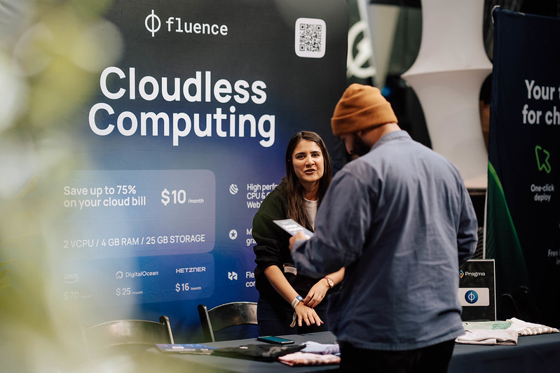 A sponsor representative speaking with an attendee at the Fluence booth