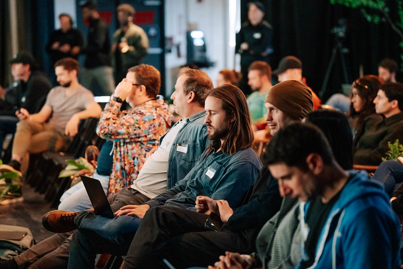 Attendees listening from their seats during an event session