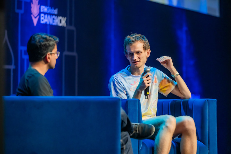 Two speakers having a seated interview on the ETHGlobal Bangkok stage